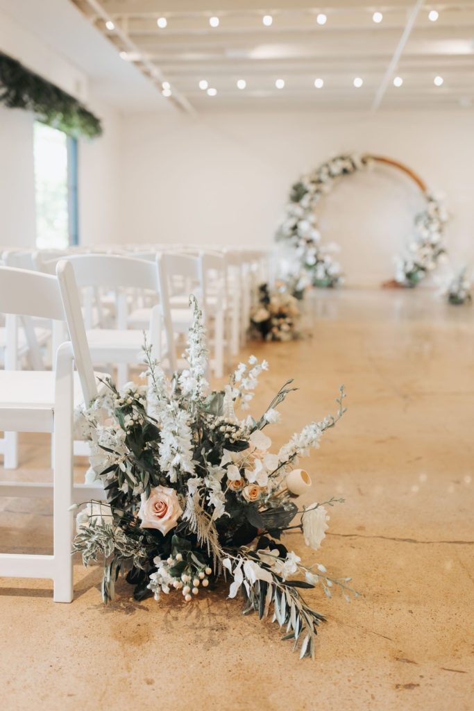 ceremony aisle floral arrangements with white and blush flowers