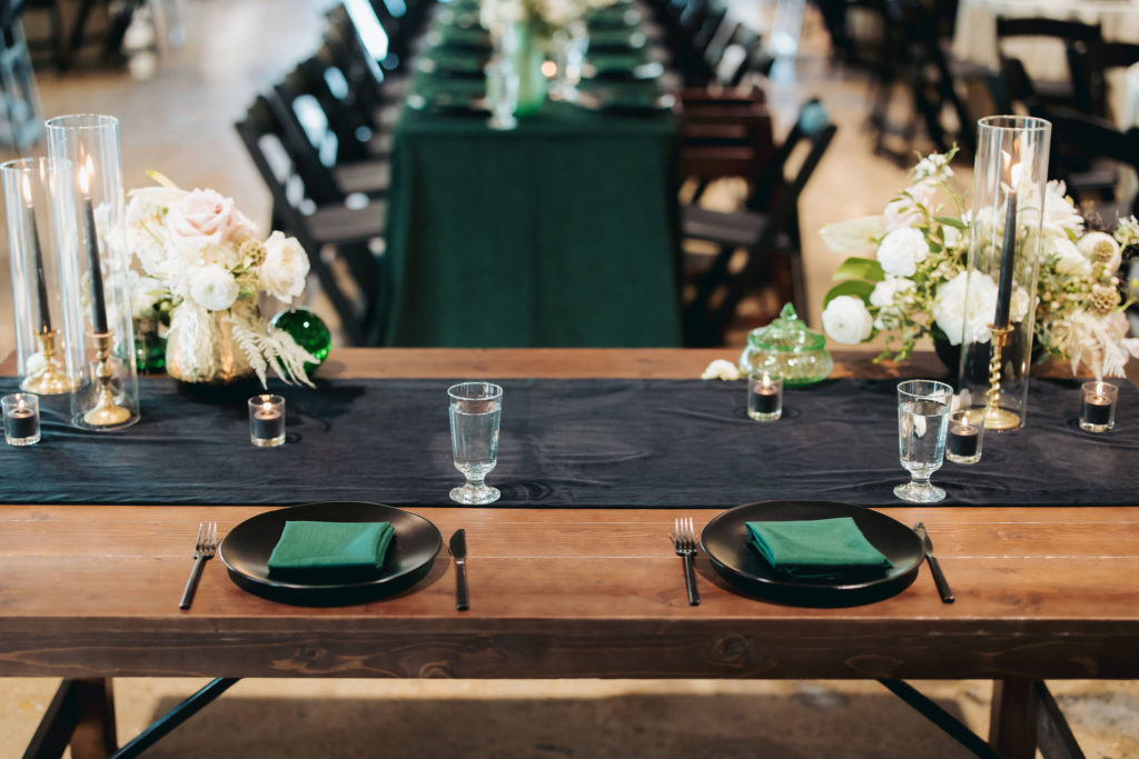 bride and groom reception table with black runner and white flowers