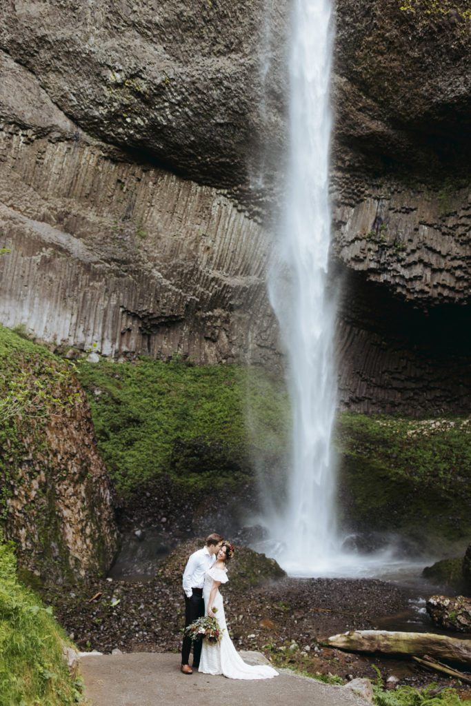 bride and groom at oregon waterfall elopement