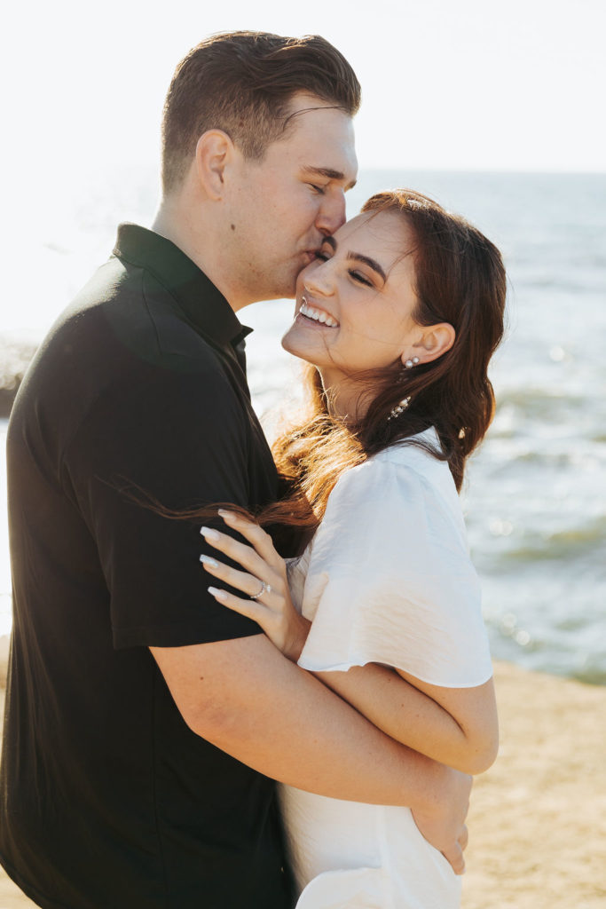 engaged couple on sunset cliffs in san diego