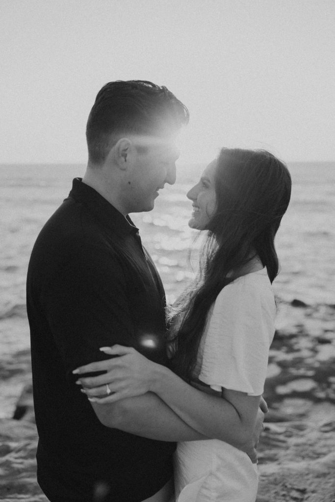 engaged couple on san diego cliffs at sunset