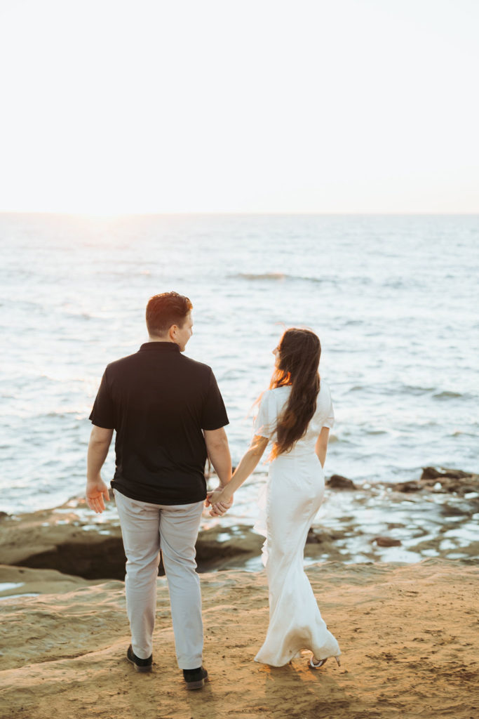 engaged couple on san diego coast at sunset