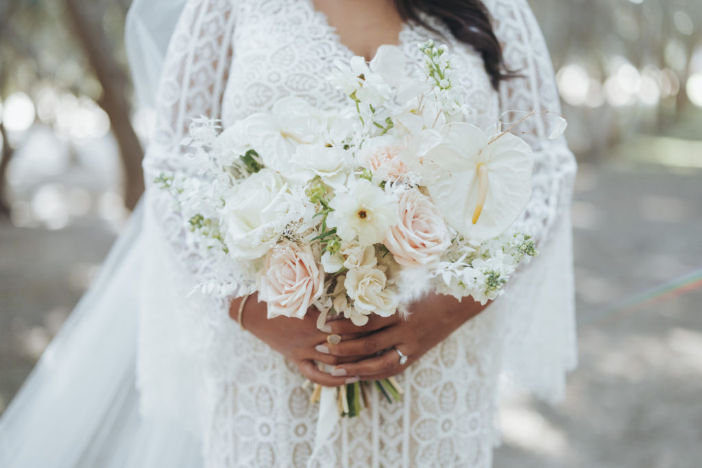 bride holding white wedding bouquet
