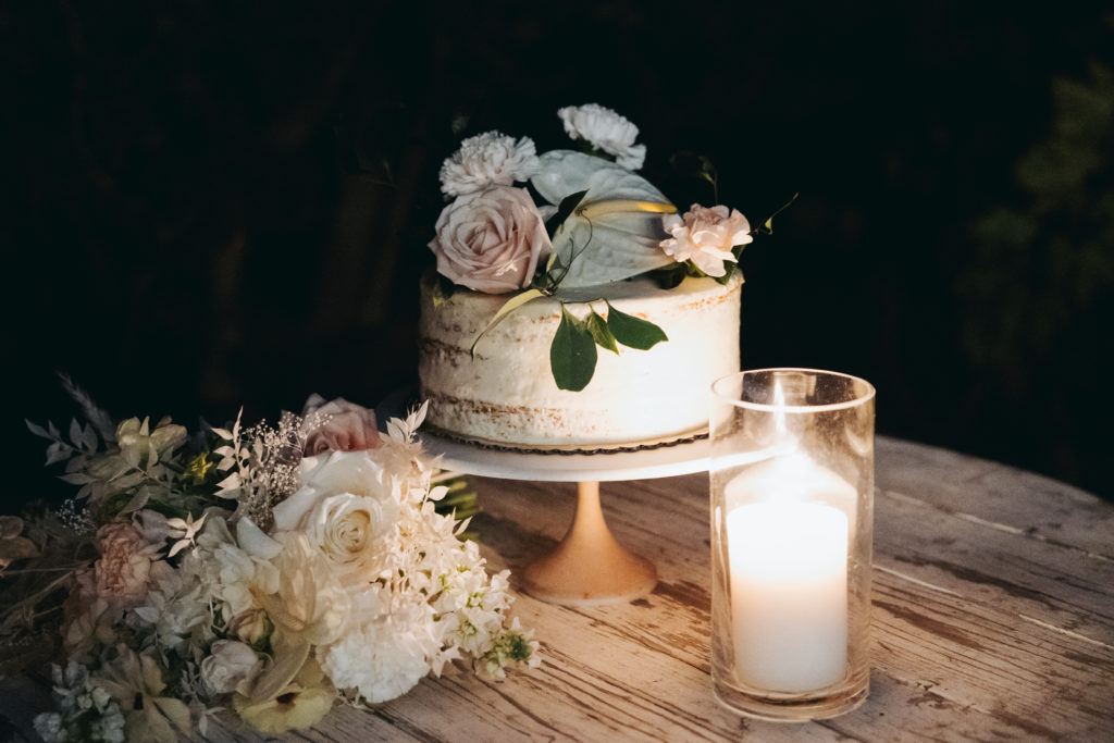 wedding cake with flowers and candle