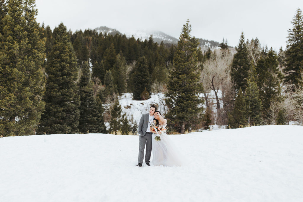 elopement couple on snowy mountain in utah