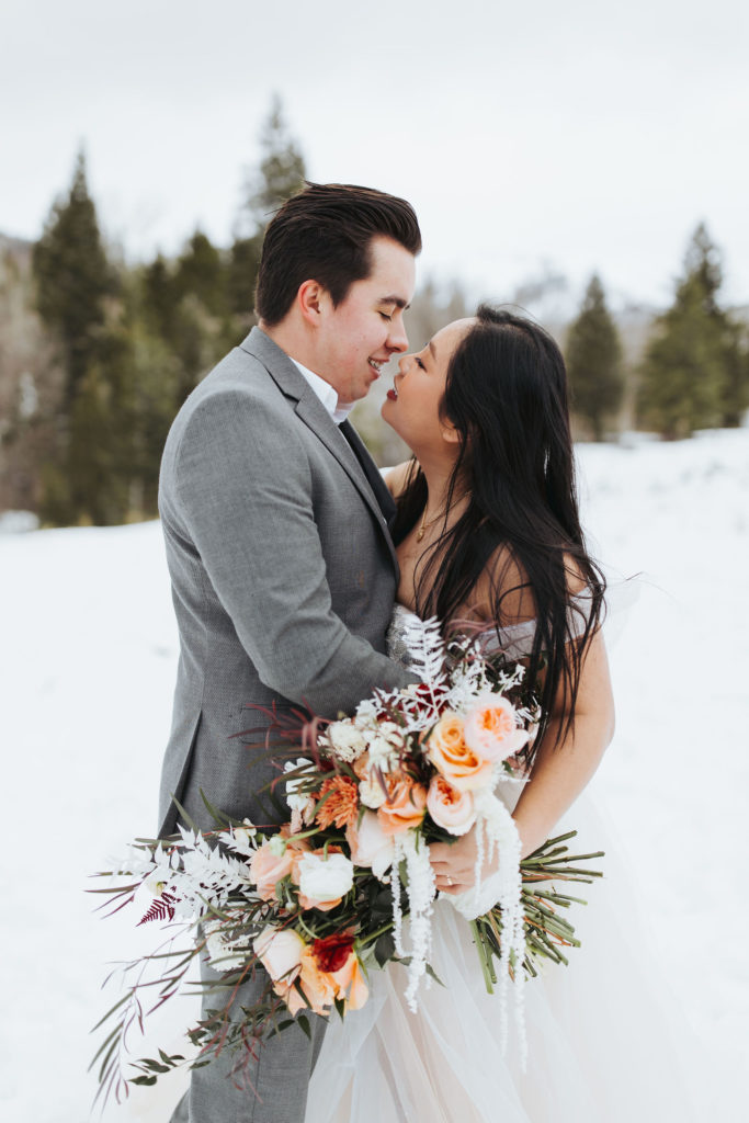elopement couple on snowy mountain in utah
