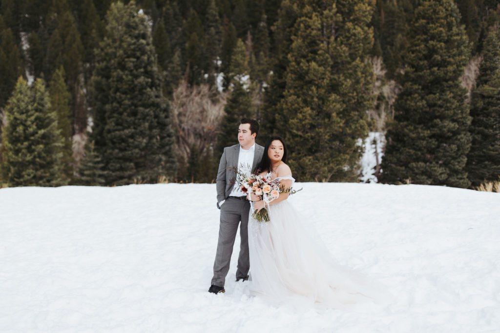 bride and groom on snowy mountain in utah elopement