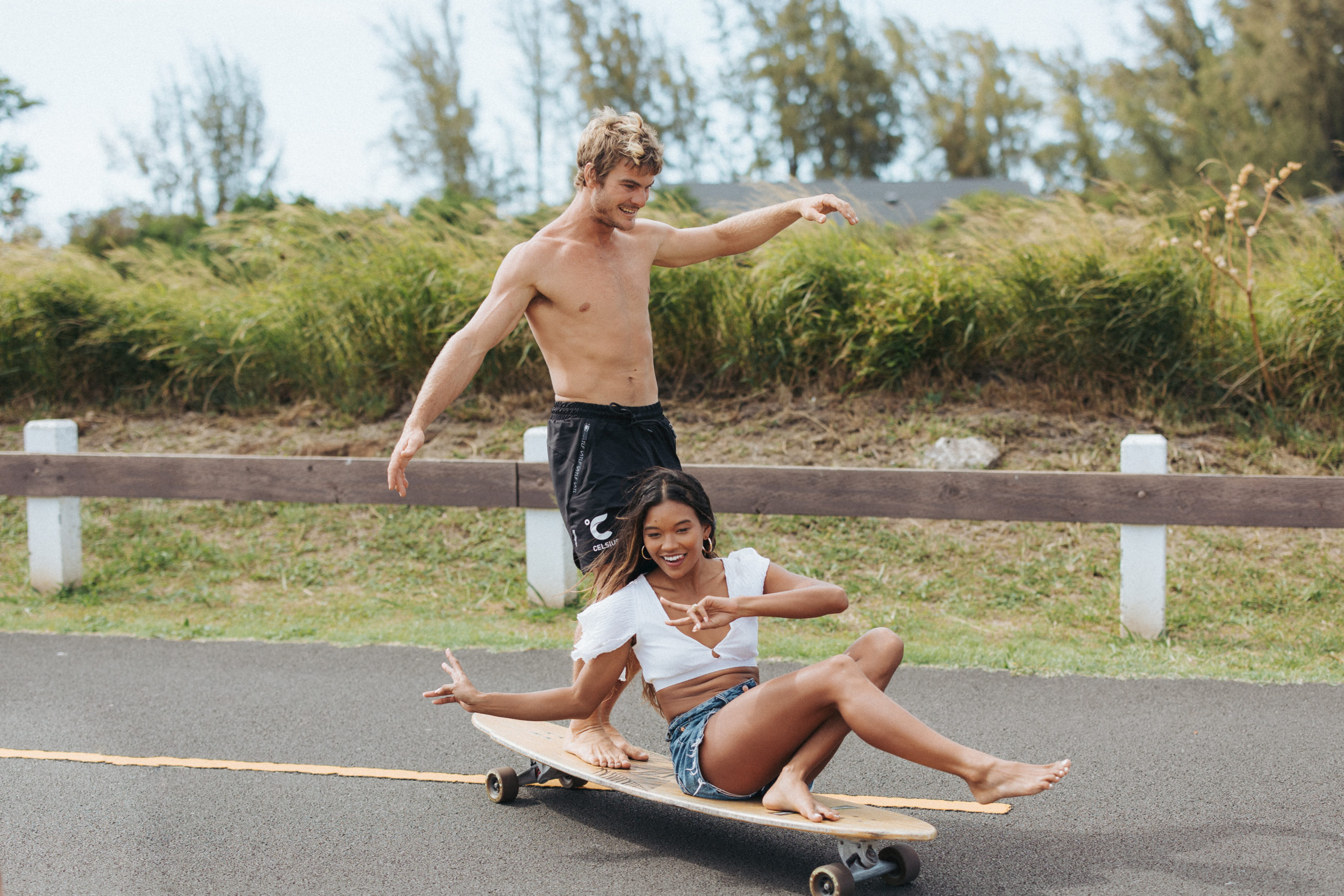 couple riding on a longboard