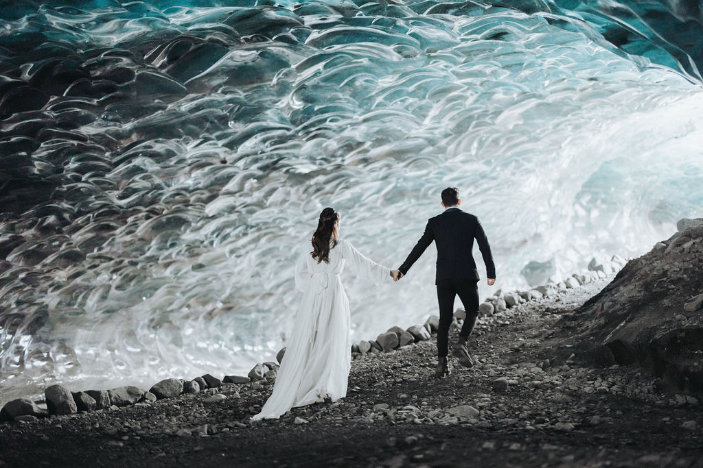 bride and groom walking through ice cave