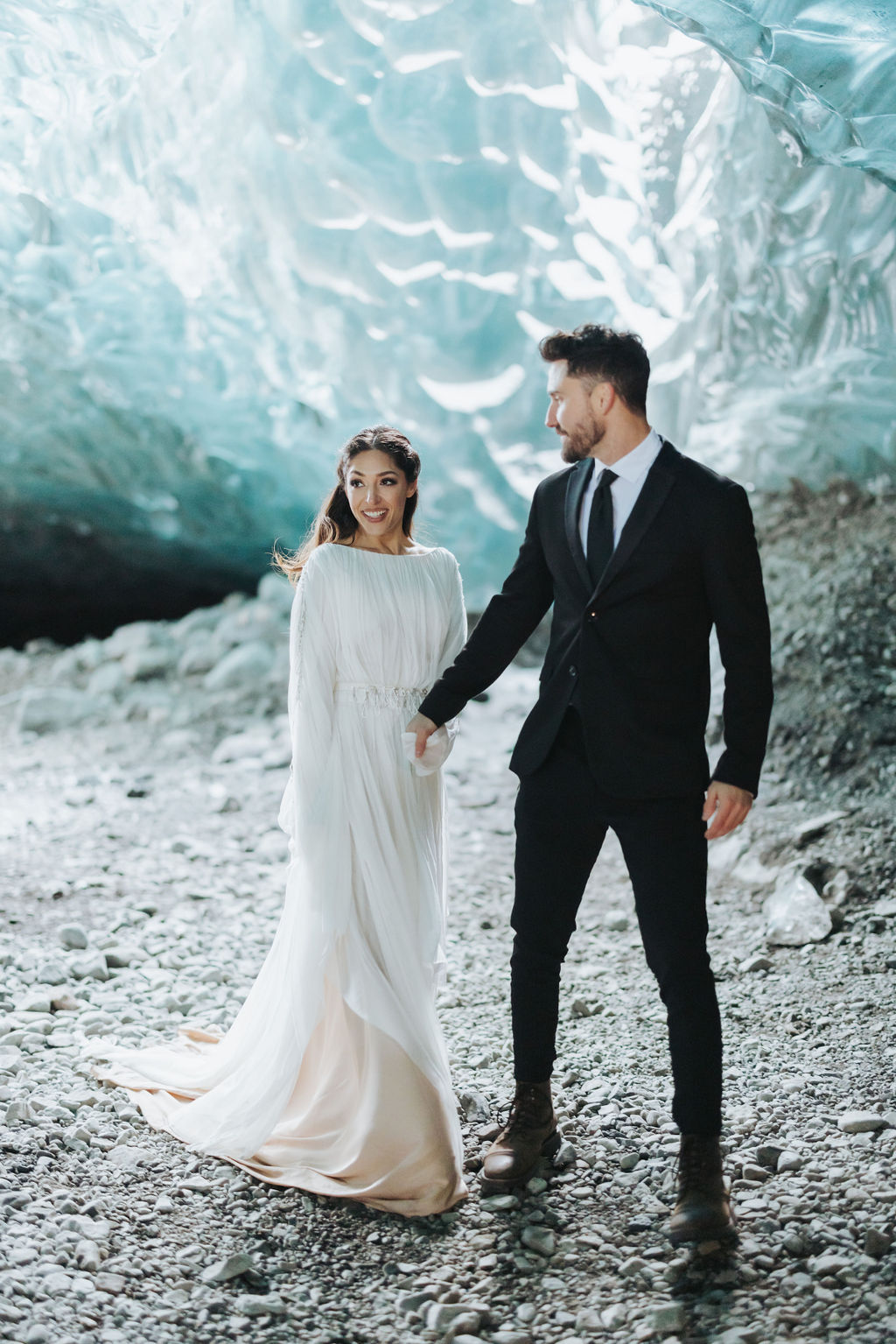 bride and groom walking in ice cave