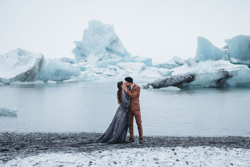couple portrait standing in front of ice cave lagoon
