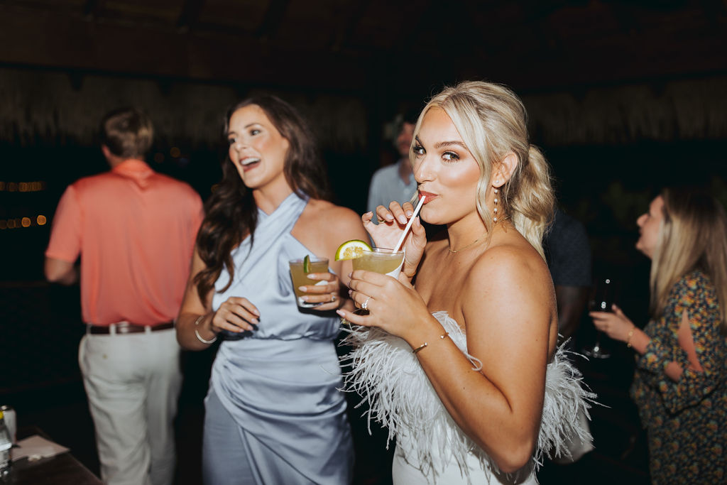 bride and bridesmaid drinking cocktails