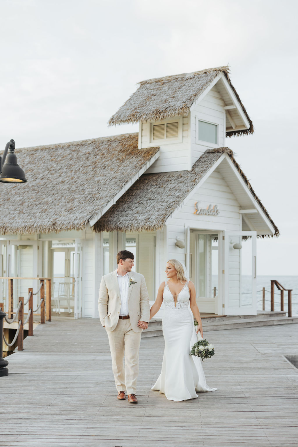 wedding couple walking on sandals water bungalow