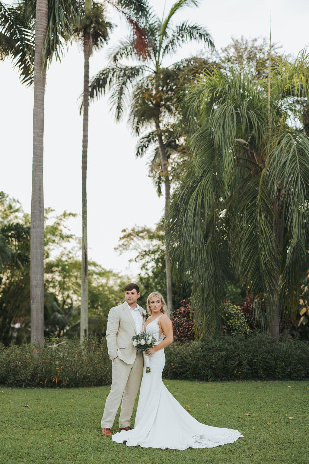 wedding portraits behind tropical garden