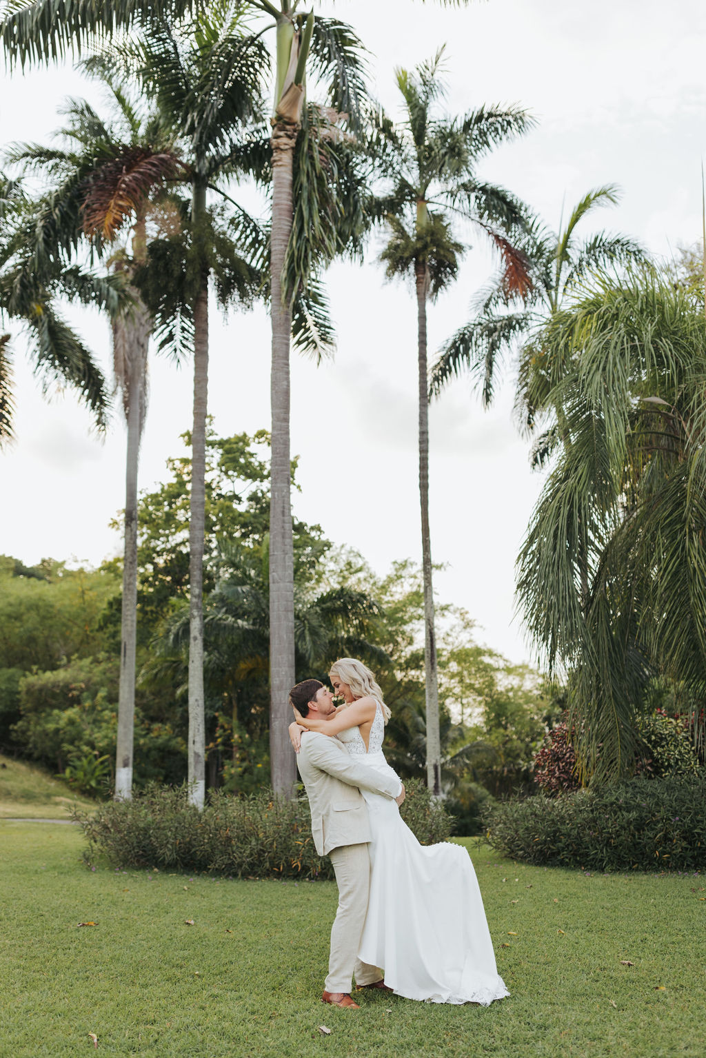 wedding portraits behind tropical garden
