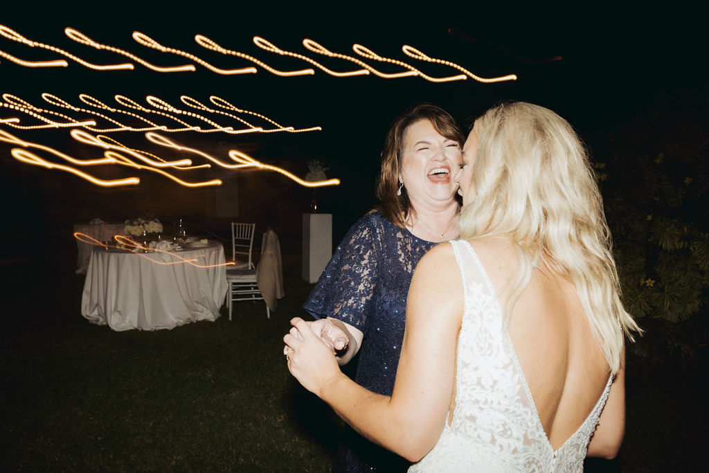 bride and mother dancing at reception