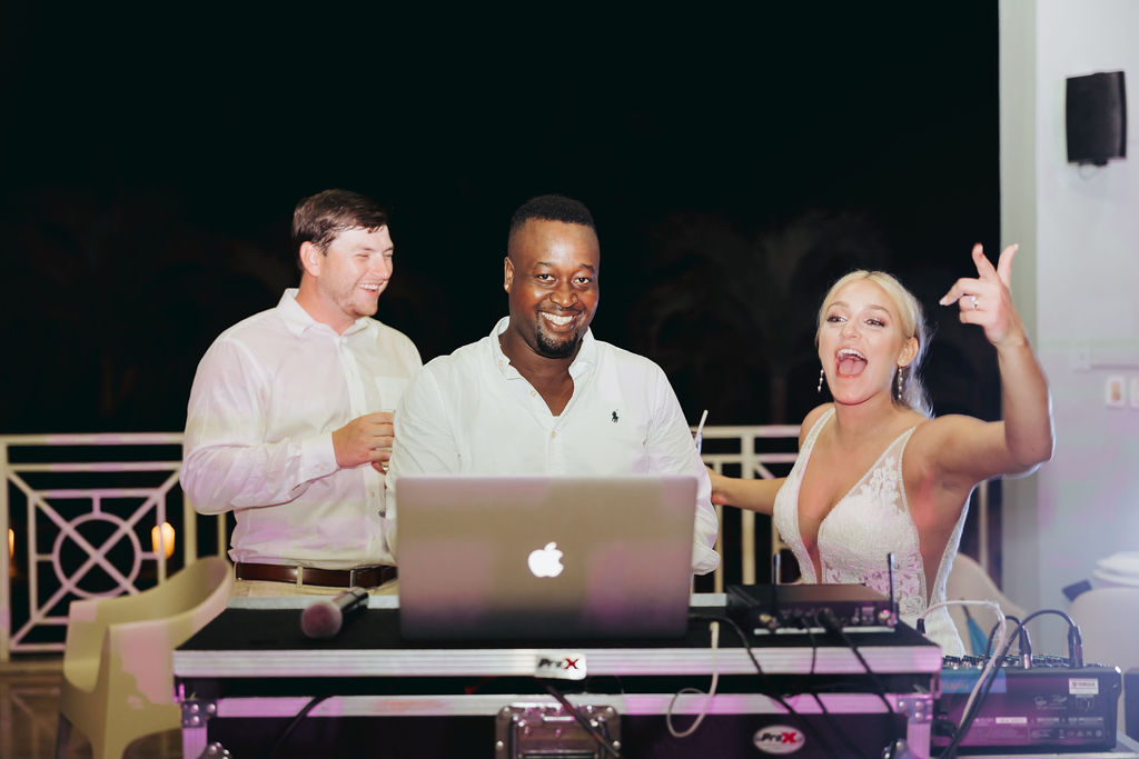 bride and groom with dj at reception