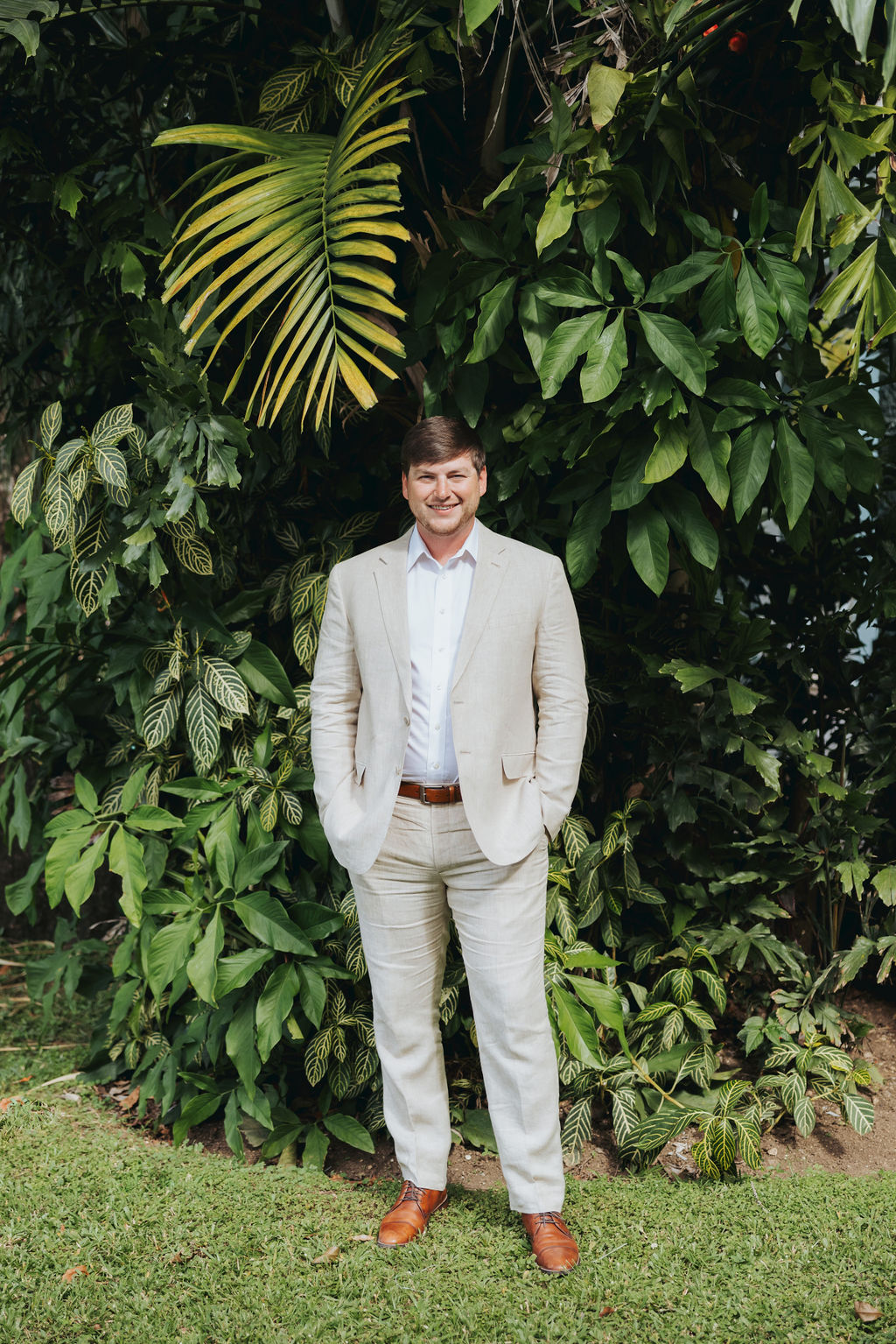 groom portrait in front of palm trees
