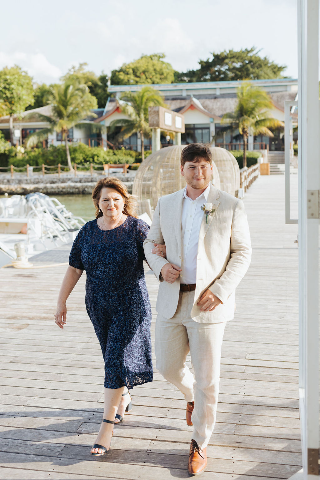 groom walking with mother