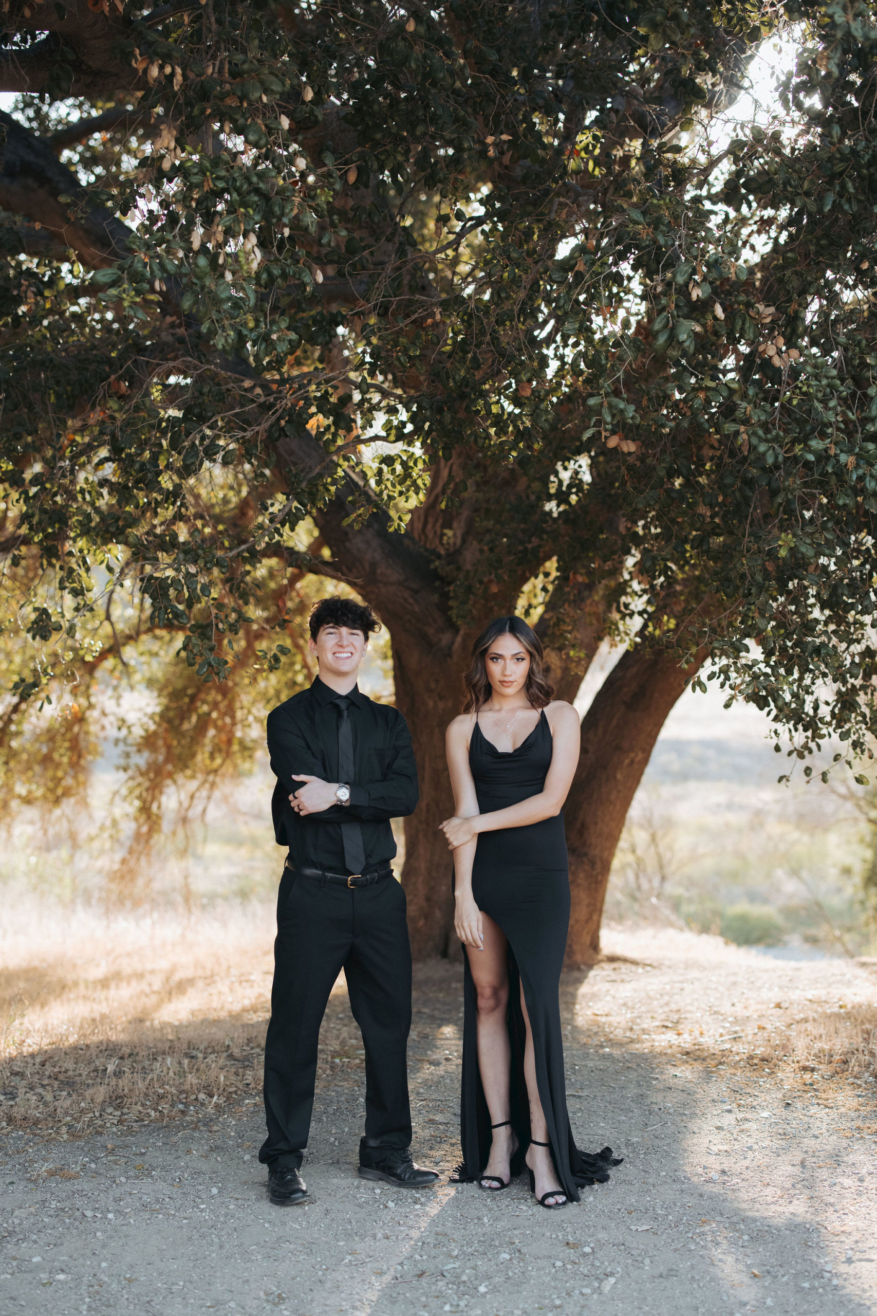 couple posing in front of tree  in Malibu Creek State Park