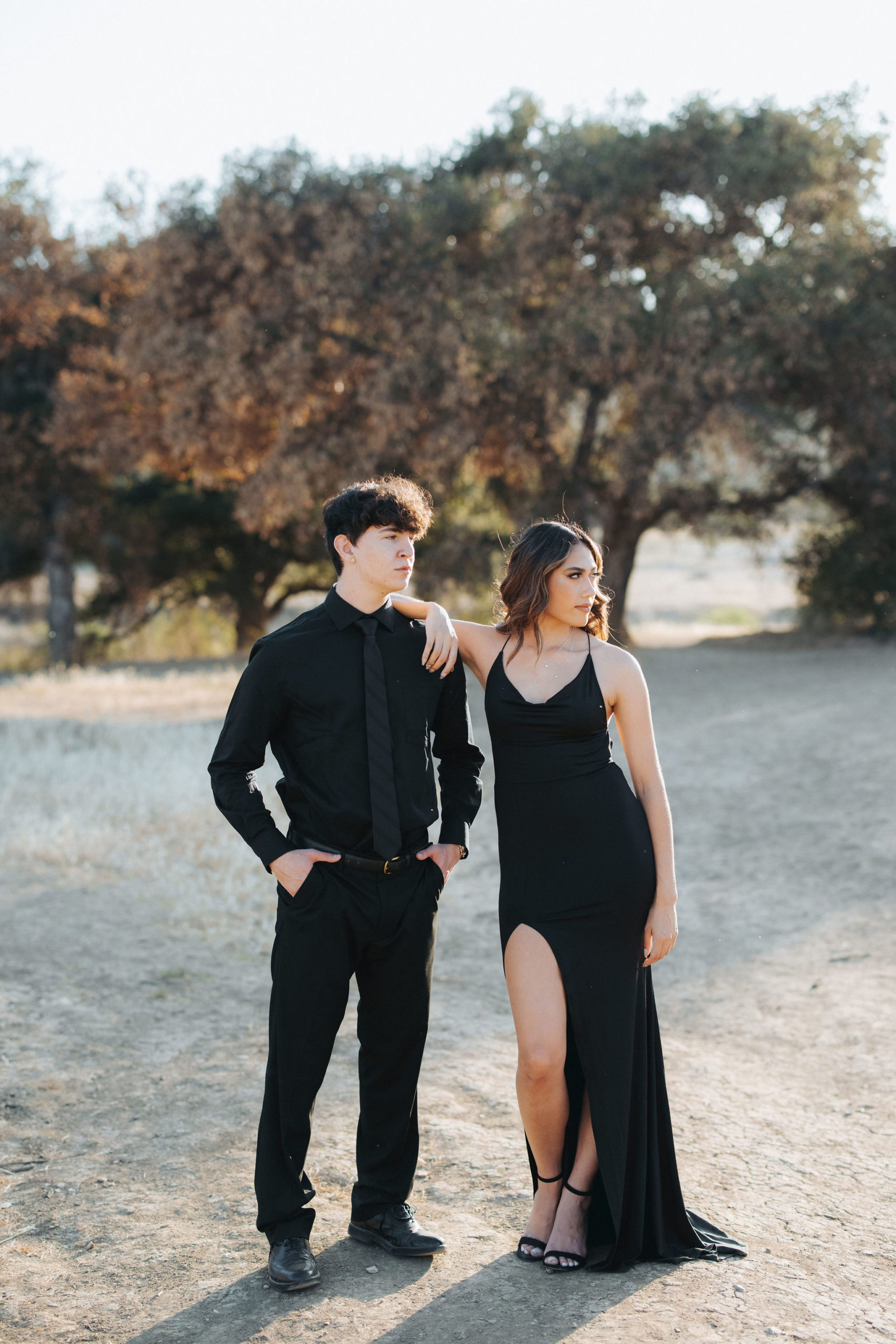 couple posing in front of trees with black clothing  in Malibu Creek State Park