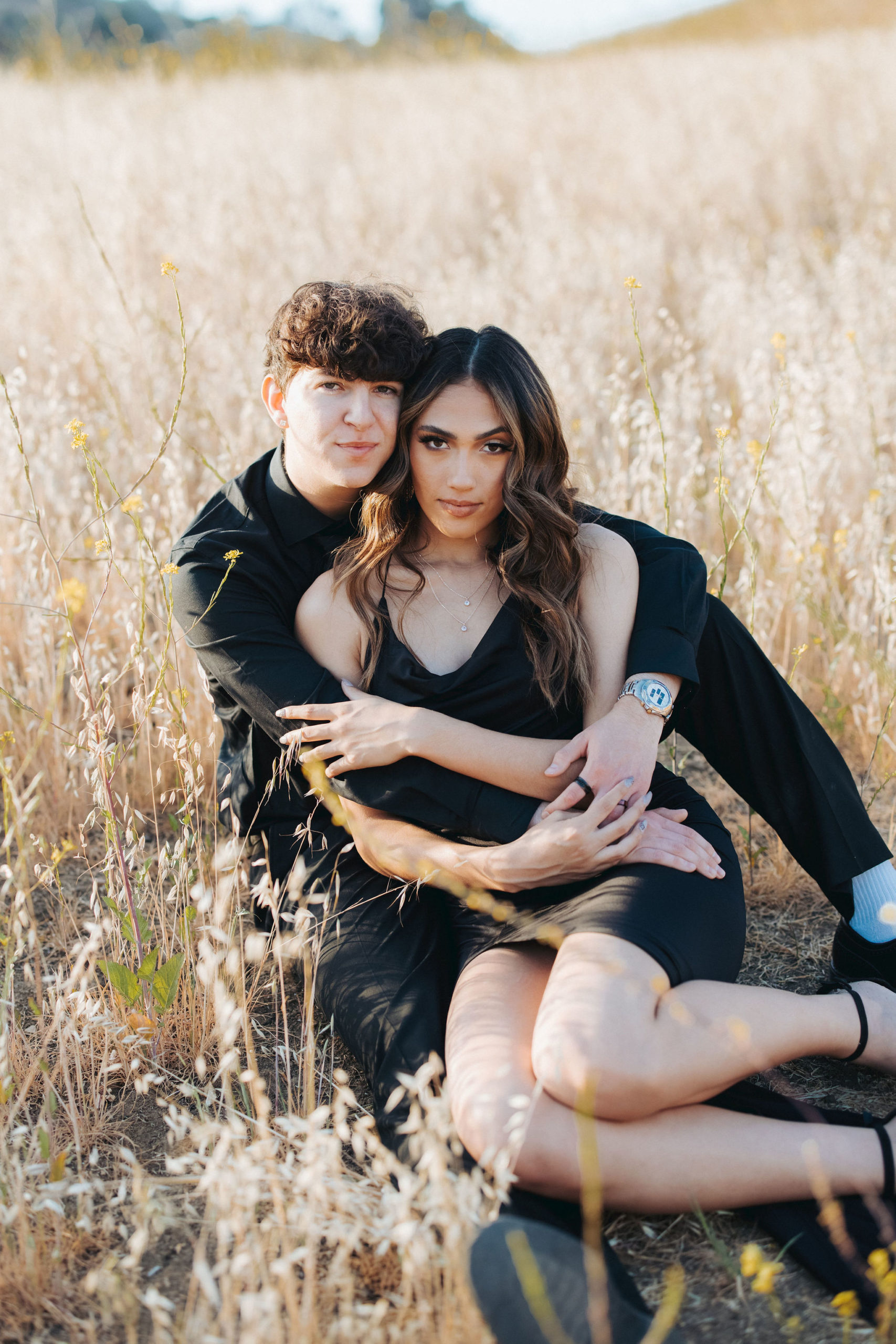 couple in black clothing among tall grass