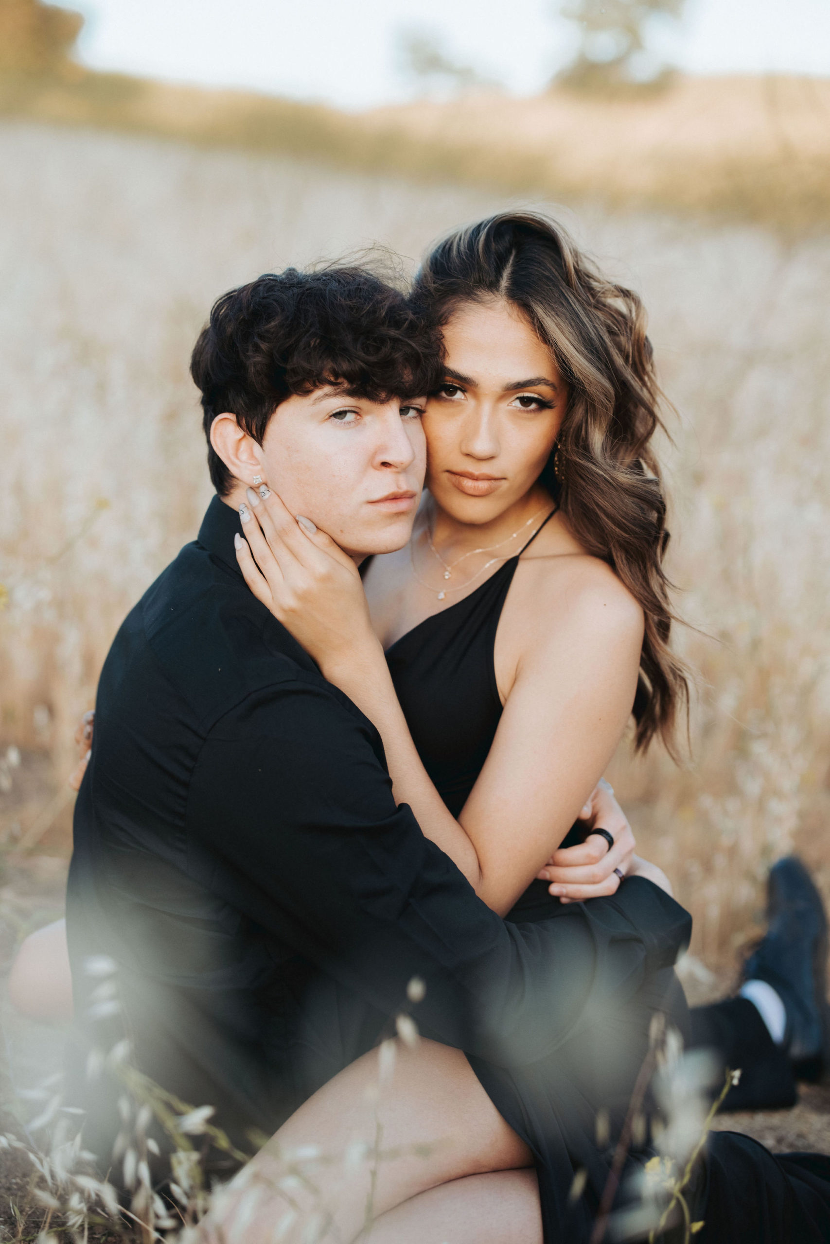 couple in black clothing among tall grass in Malibu Creek State Park