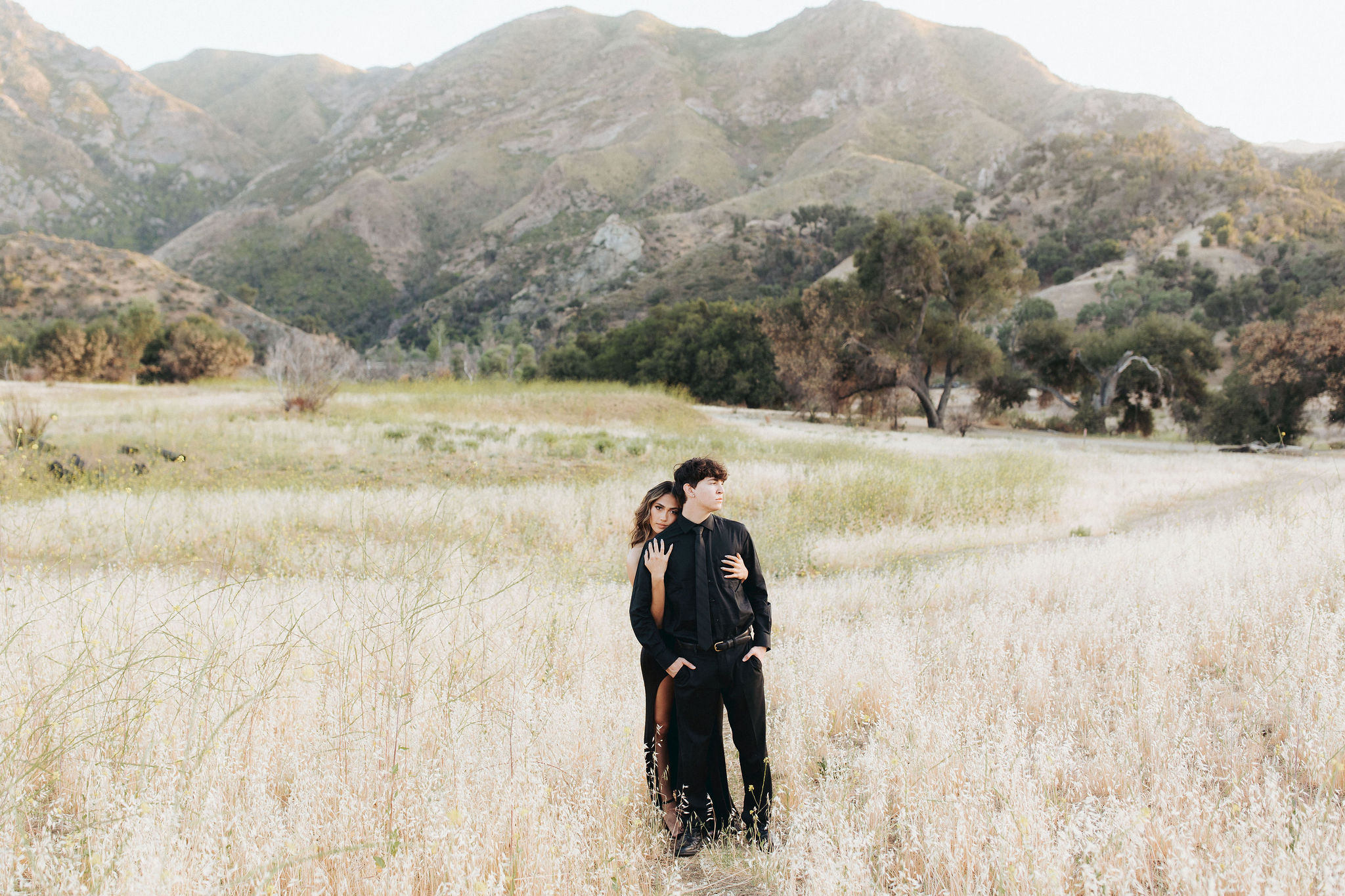 couple hugging in front of mountains