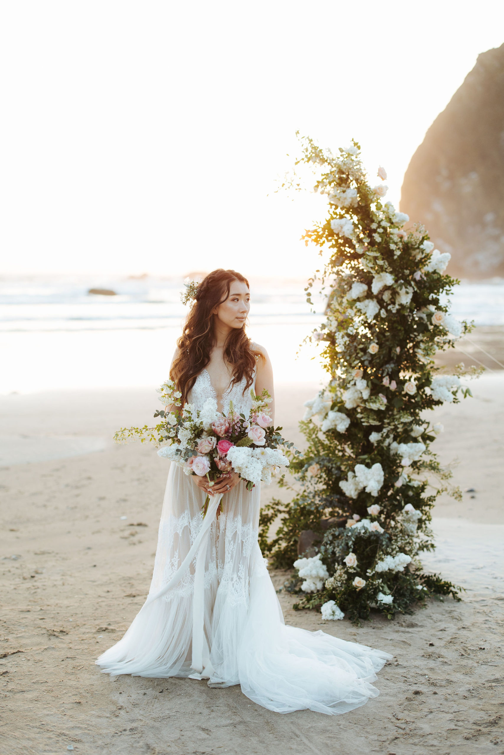 bride portrait on beach with flower arch and candlesbride portrait on beach with flower arch and candles