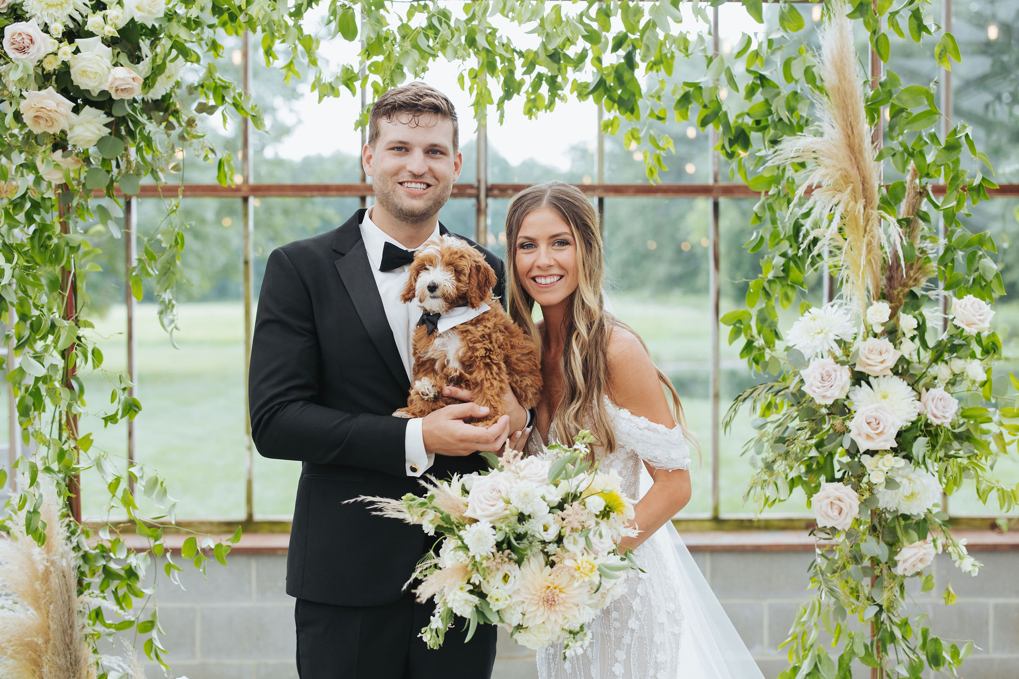 bride and groom portrait with puppy