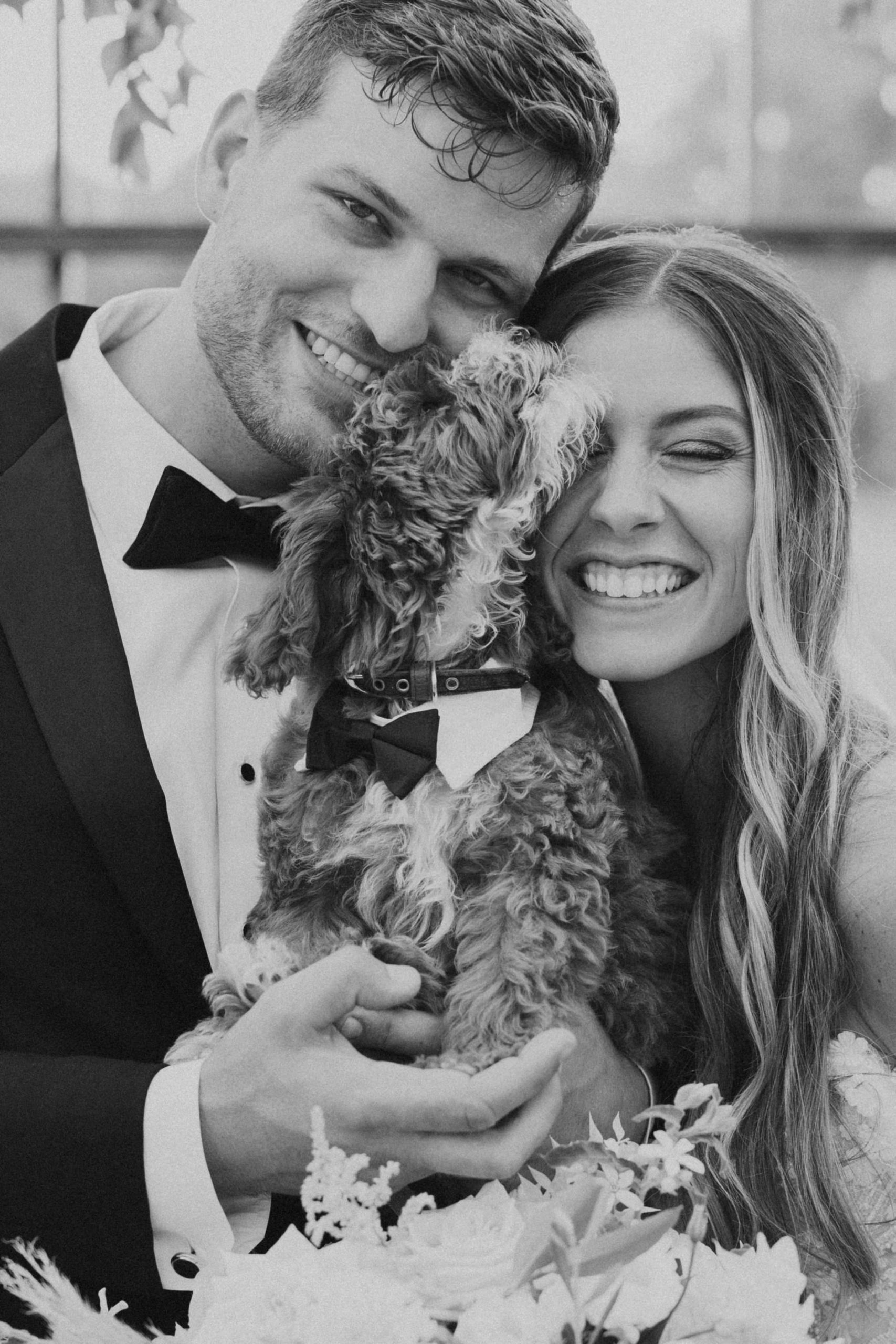 bride and groom portrait with puppy