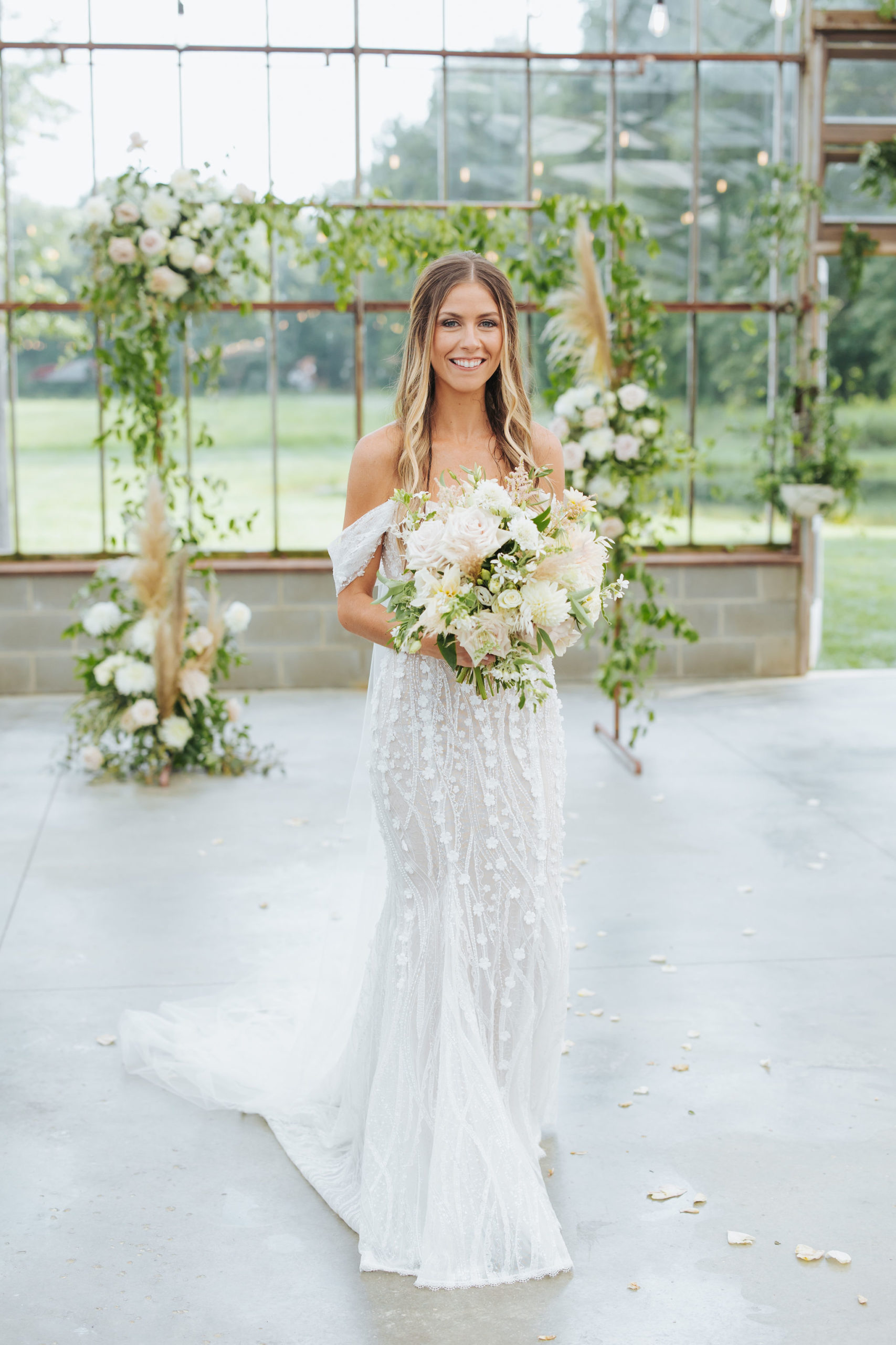 bridal portrait in front of floral arch