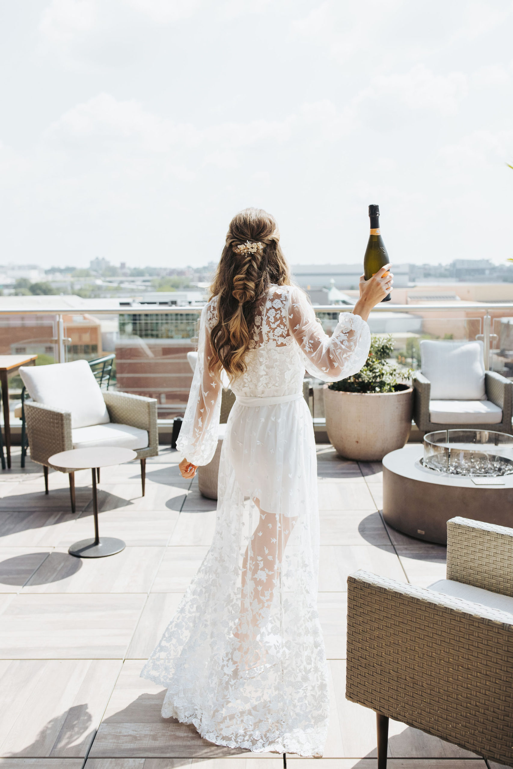 bride in getting ready robe with champagne
