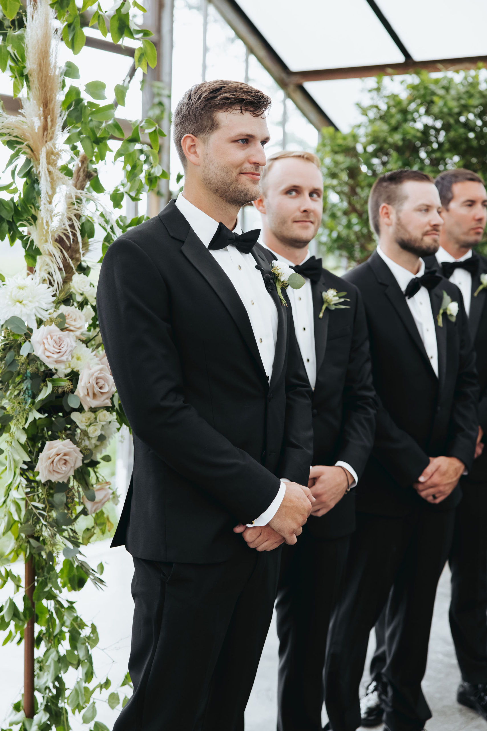 groom standing at the alter with groomsman