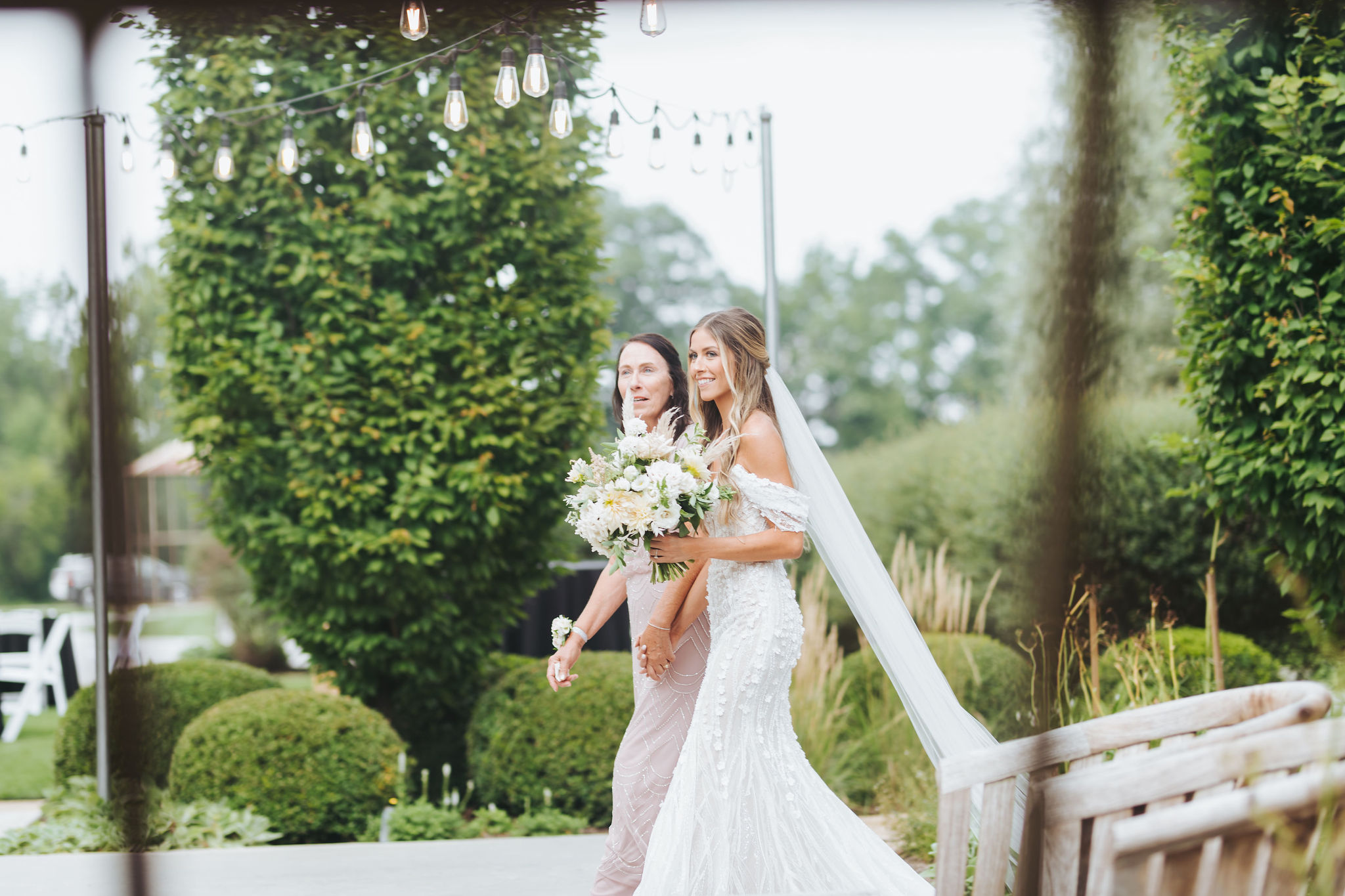 bride walking down the aisle with her mother