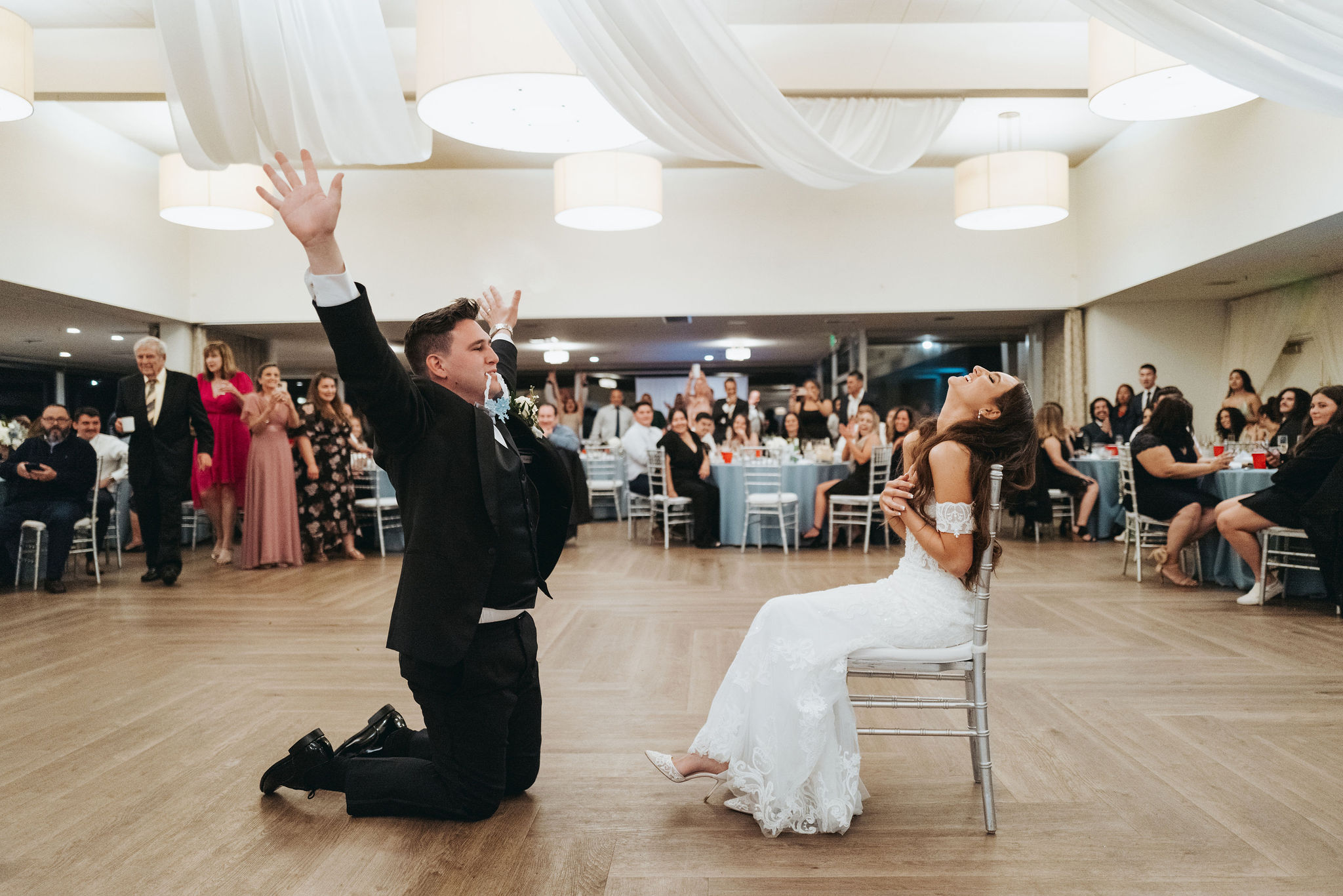 bride and groom garter toss at reception