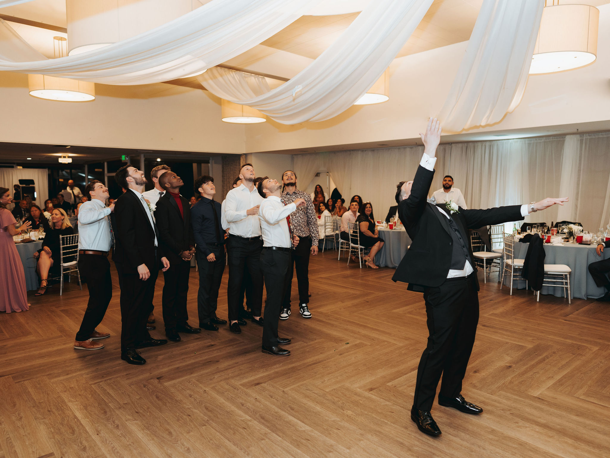 bride and groom garter toss at reception