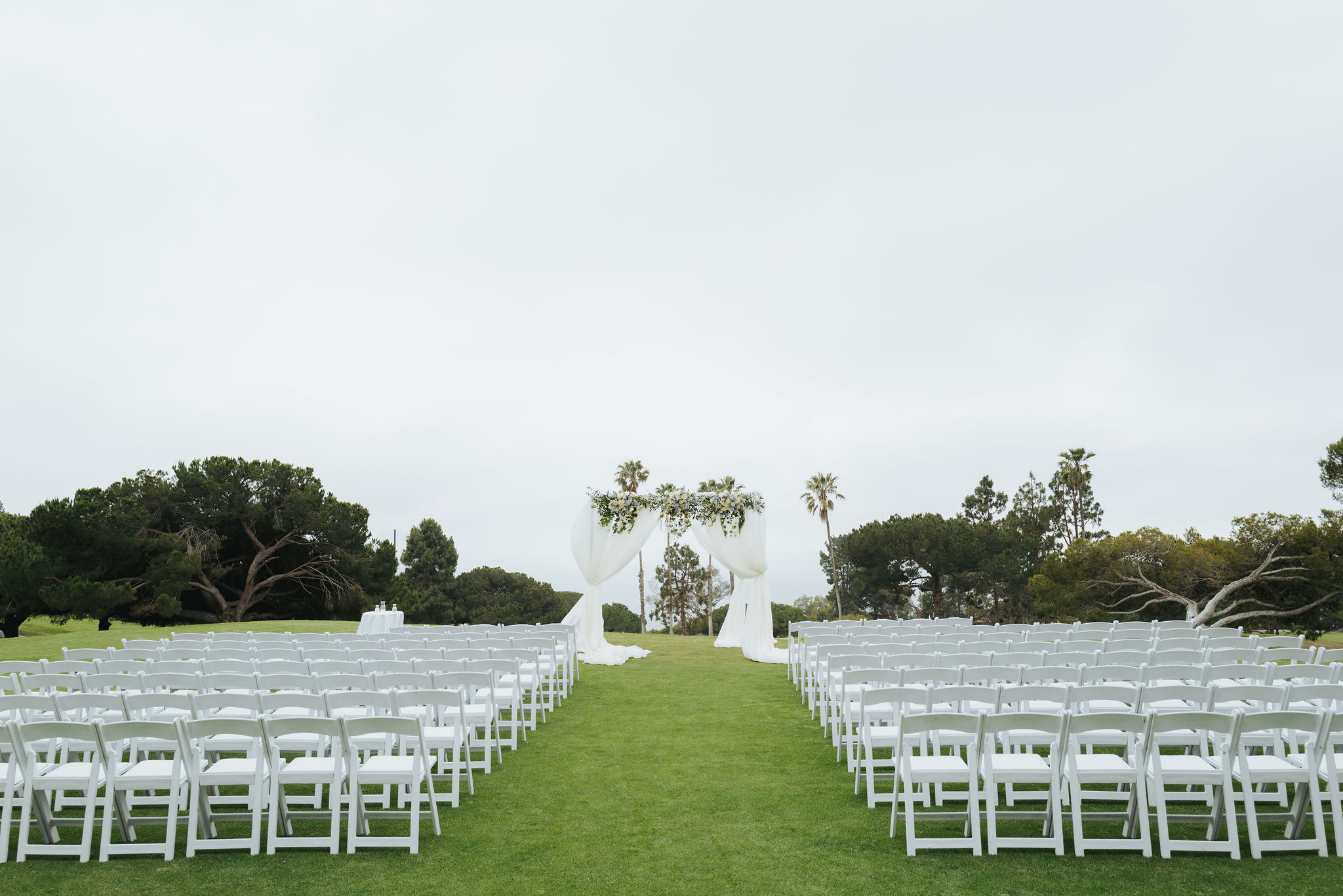 white chairs and backdrop wedding ceremony