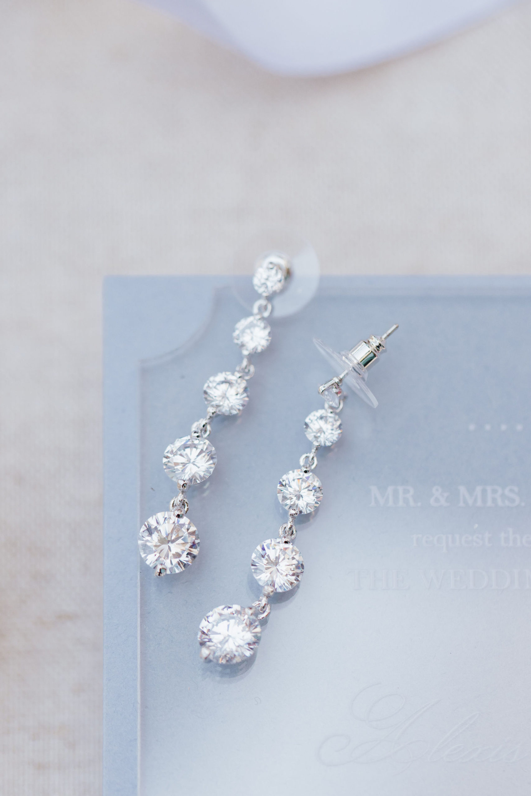 blue wedding invites with diamond earrings