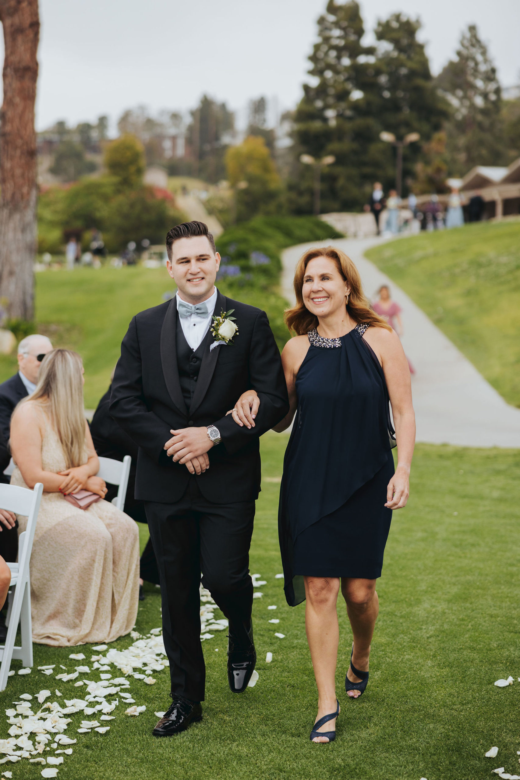 groom walking mother down the aisle
