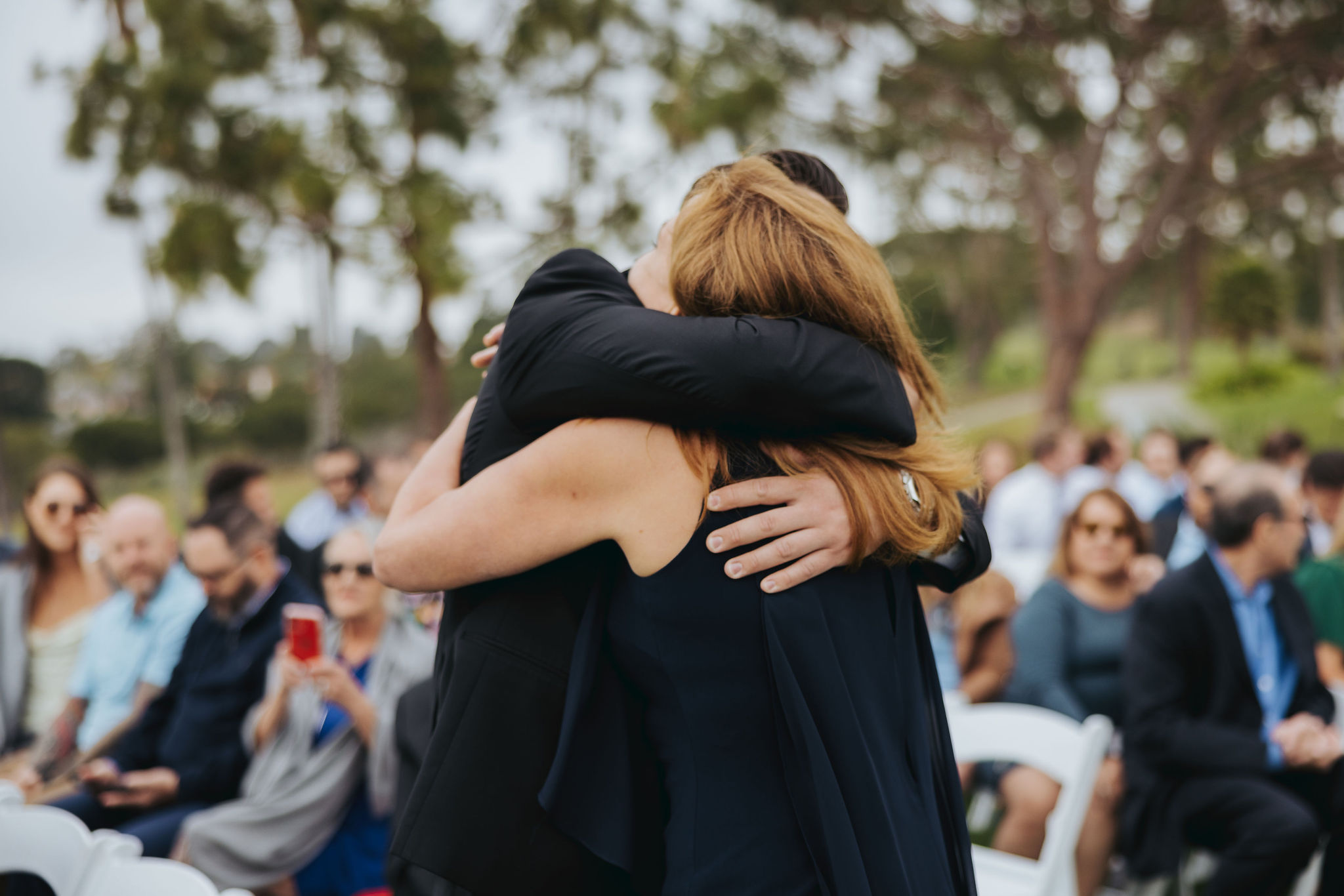 groom hugging mother at wedding
