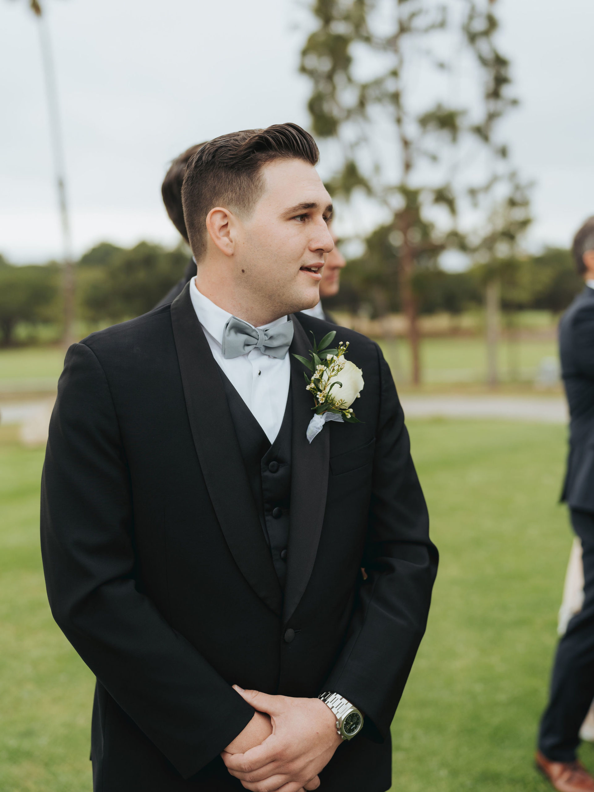 groom standing at the end of the aisle