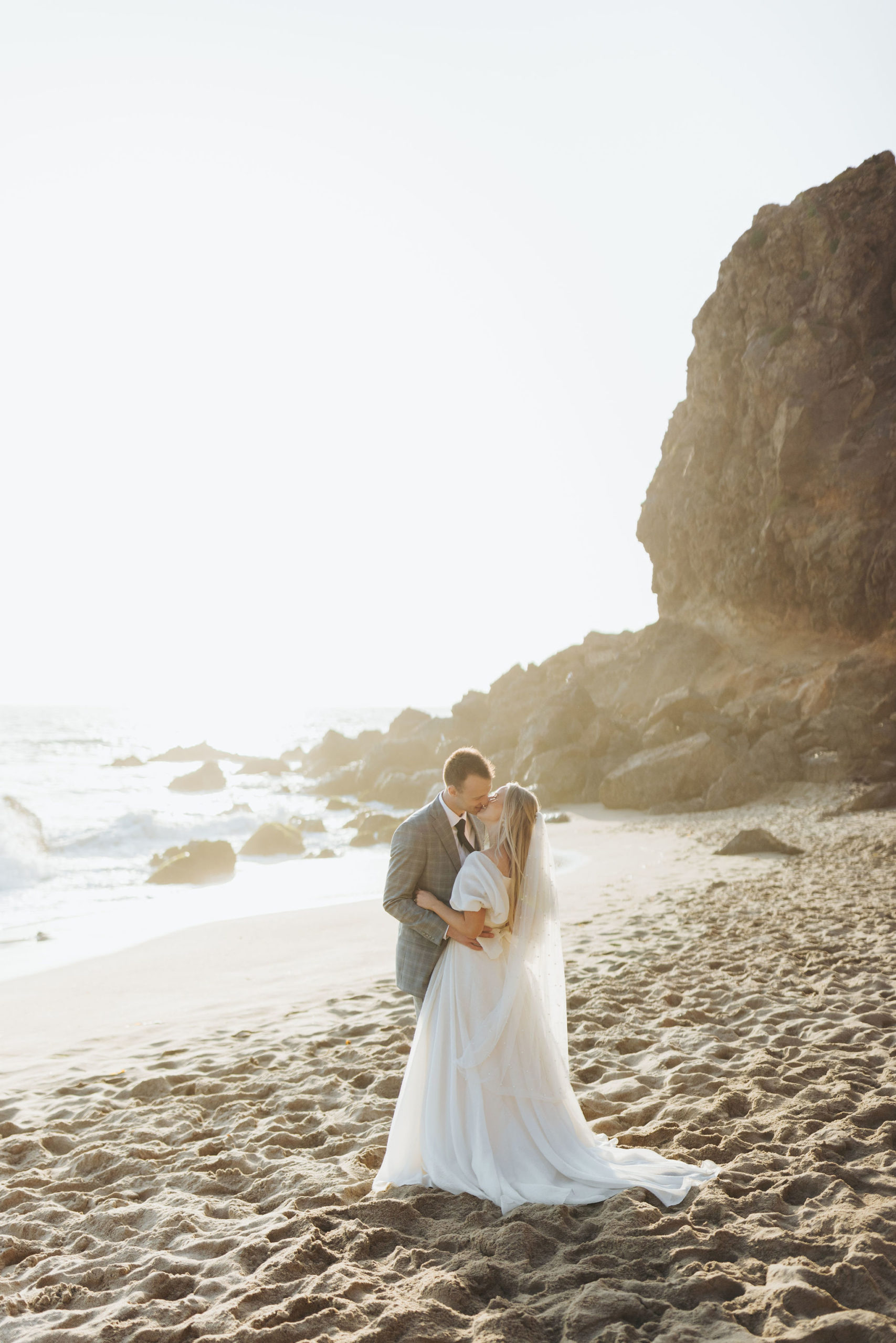 bride and groom kissing on a beach golden hour at Point Dume