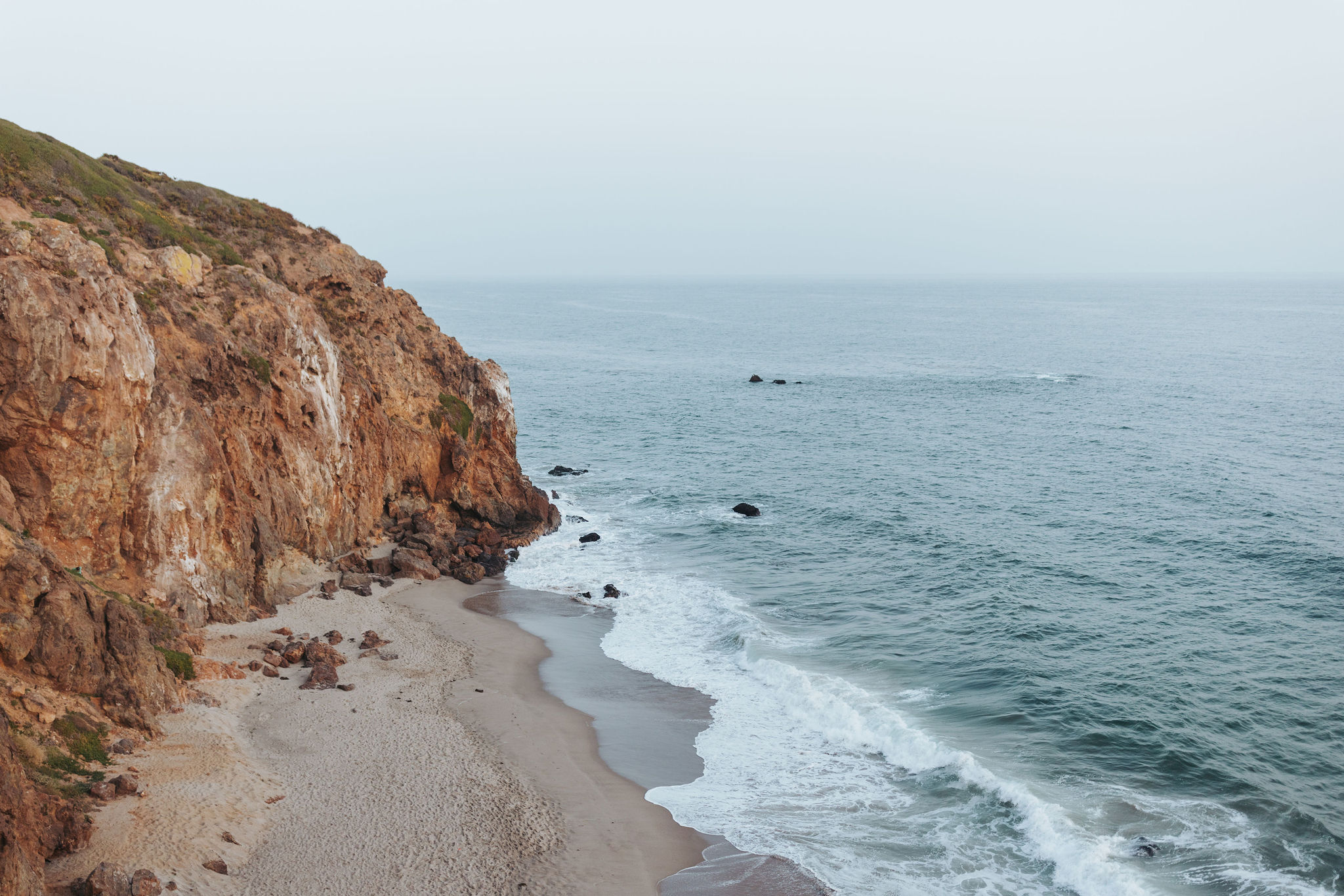 rocky beach cliff overlooking water