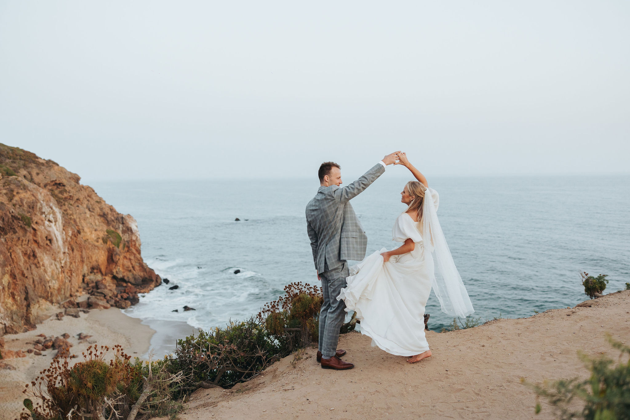 bride and groom dancing on a beach at Point Dume