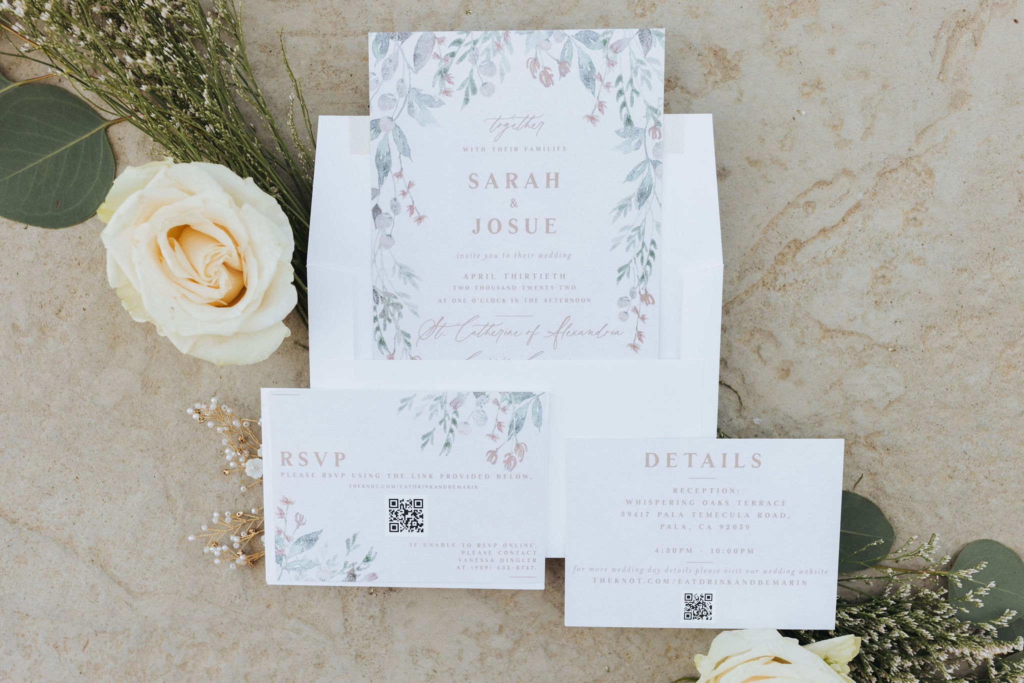 wedding invitations with flowers and gold jewelry