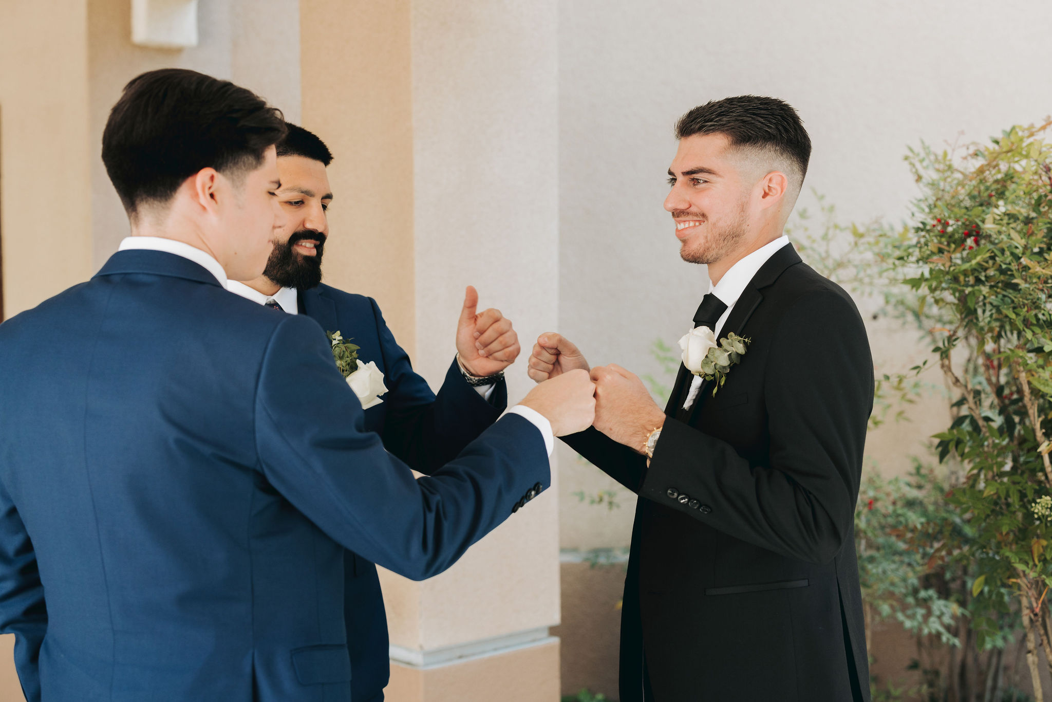 groomsmen giving groom fist bump before wedding ceremony in temecula california