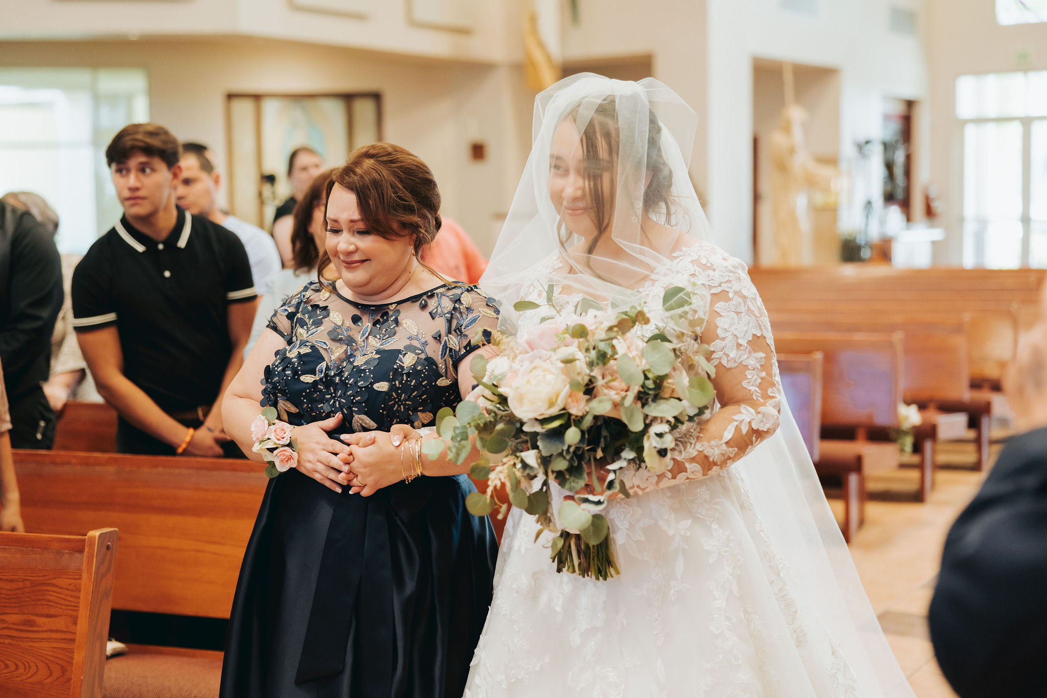 bride walking down the aisle with her mother during wedding ceremony in temecula california