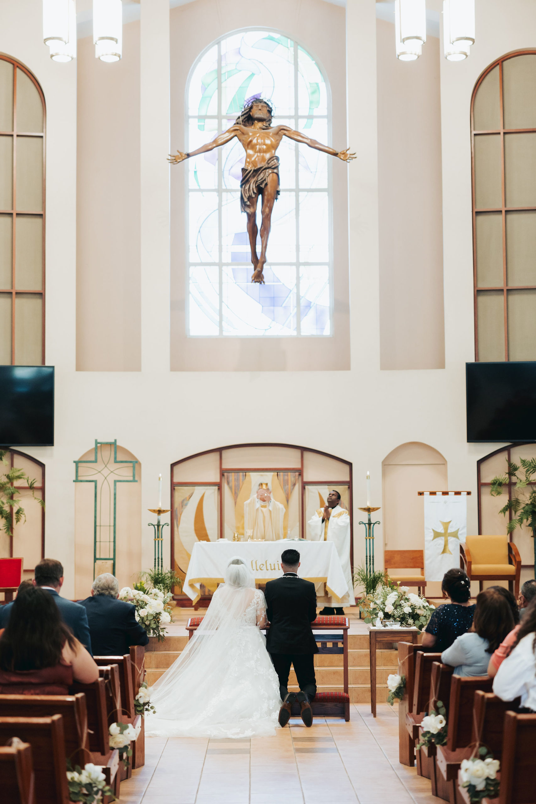 bride and groom kneeling at altar during the wedding ceremony in temecula california