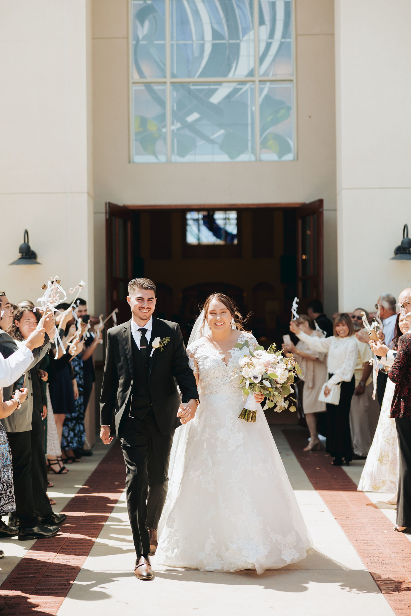 bride and groom exiting church after ceremony after wedding ceremony in temecula california